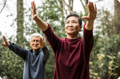 Two Asian people stretching outside
