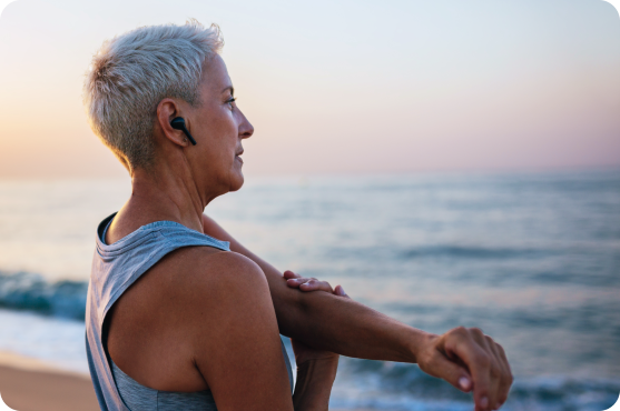 Older woman looking at the sea during sunrise